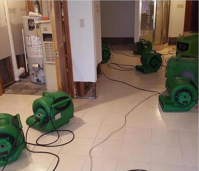 cleaned area, servpro machines drying the basement